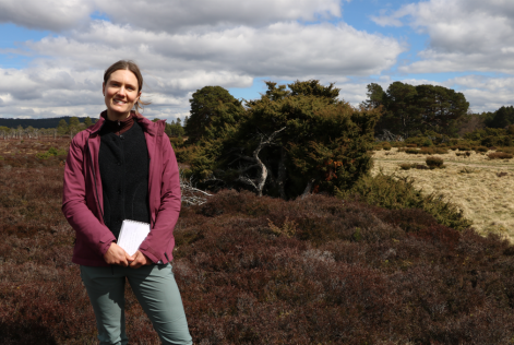 Photo of Amy standing in area of heathland 